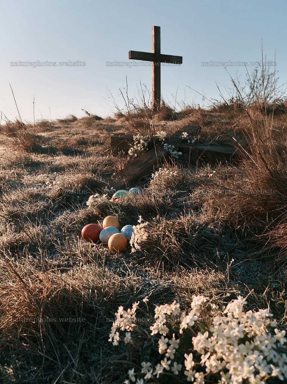 Christian cross in frost-covered meadow with colorful eggs – nature photos 6866x9174