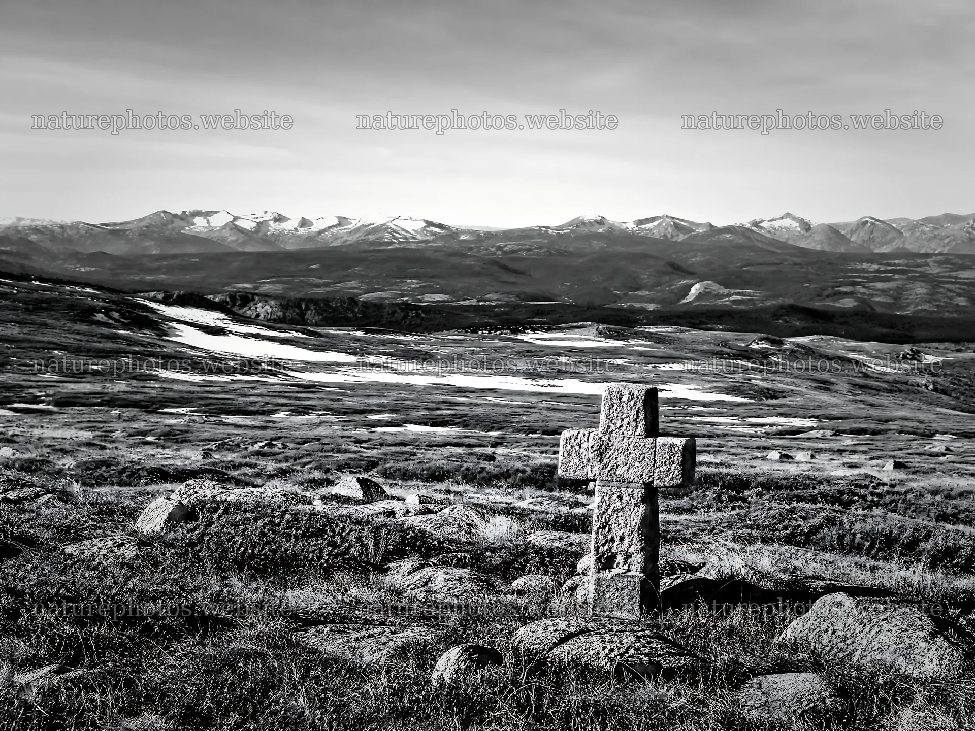 Christian cross in deep mountain valley during winter – nature photos 9166x6874
