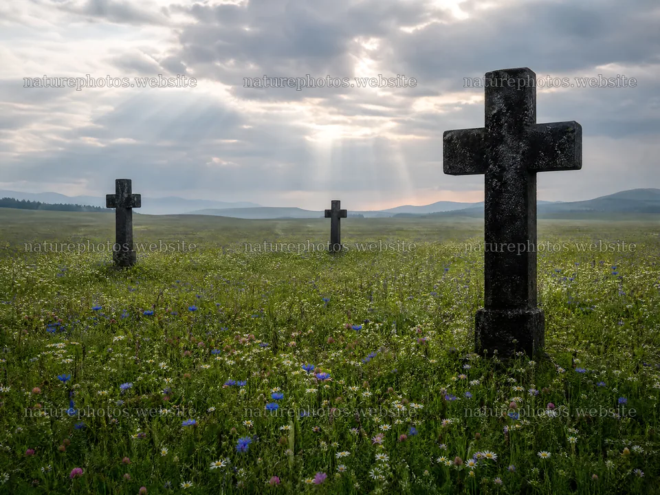 Christian crosses in meadow with sun rays and cloudy sky – nature photos 9166x6874