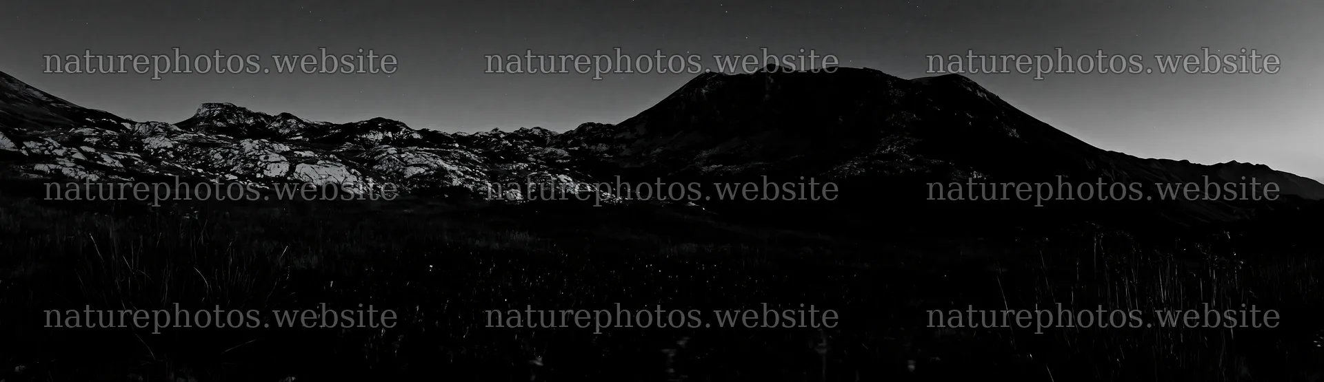 Starlit meadow at night with distant mountains and clear sky – nature photos 14762x4268
