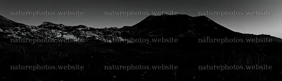 Starlit meadow at night with distant mountains and clear sky – nature photos 14762x4268