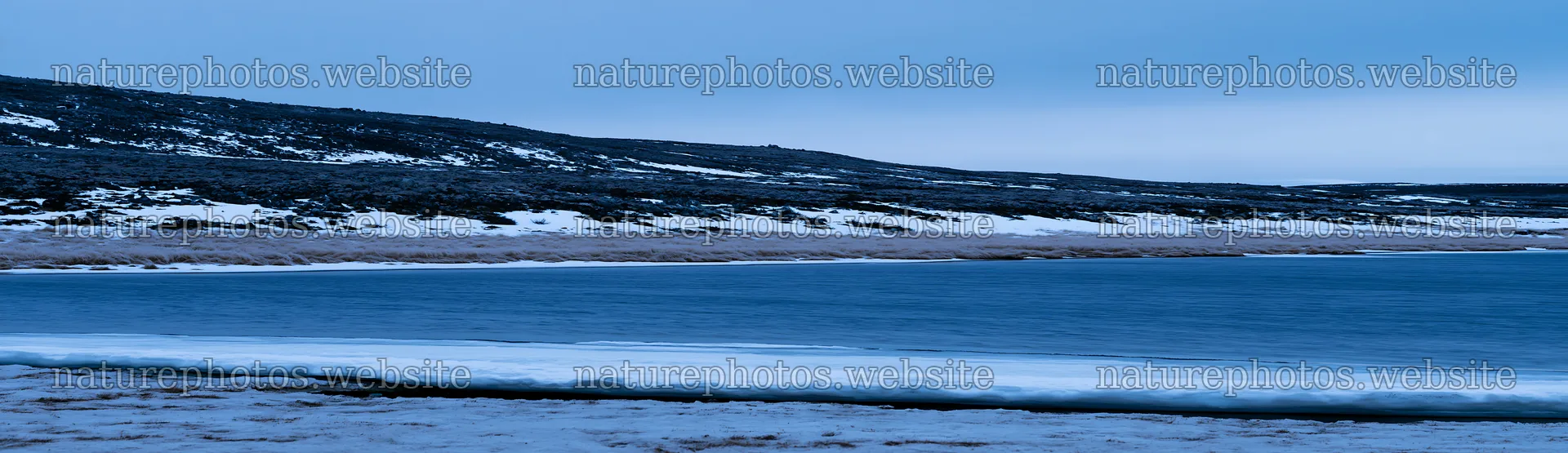 Snowy highland meadow with frozen water and distant hills – nature photos 14762x4268